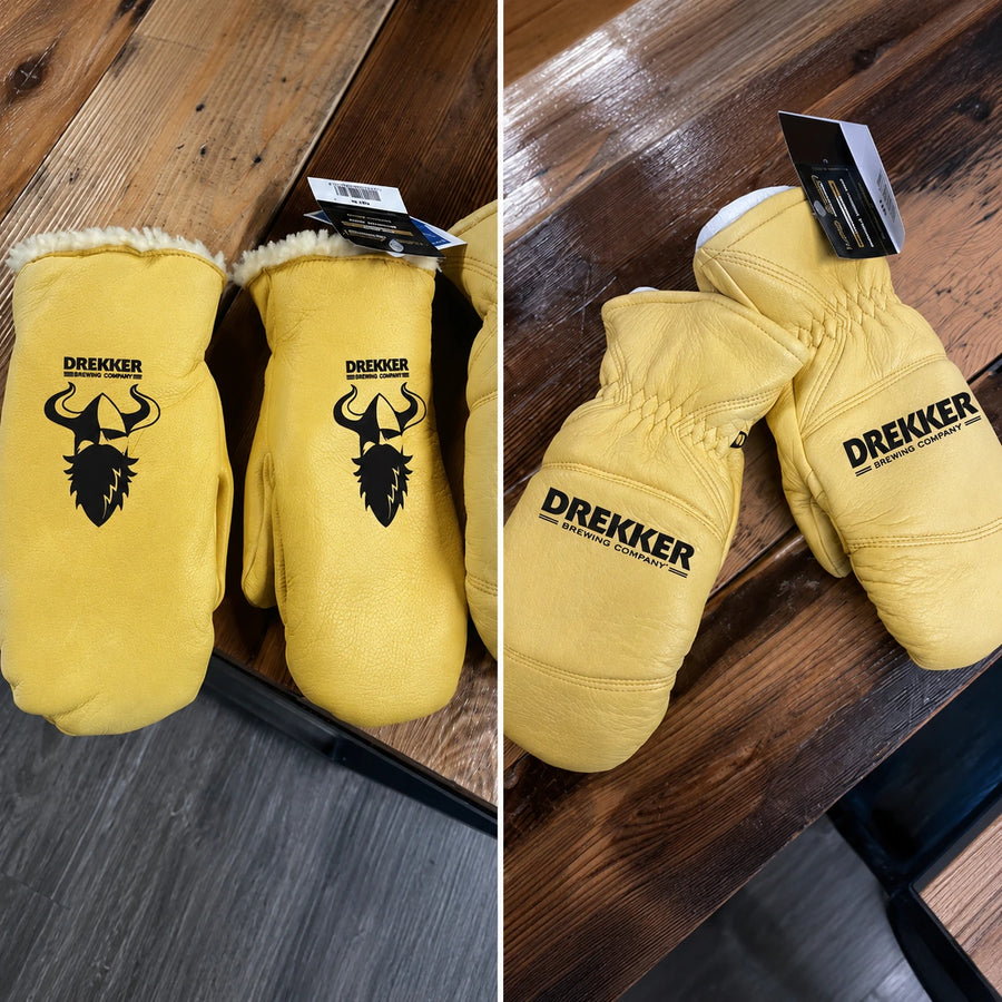 Yellow boxing gloves with Drekker branding on a wooden surface