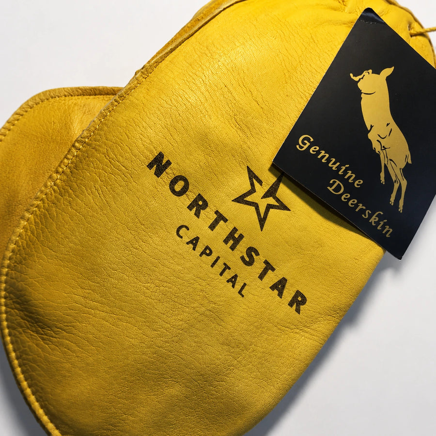 Yellow leather product with 'Northstar Capital' branding and a 'Genuine Deerskin' tag.